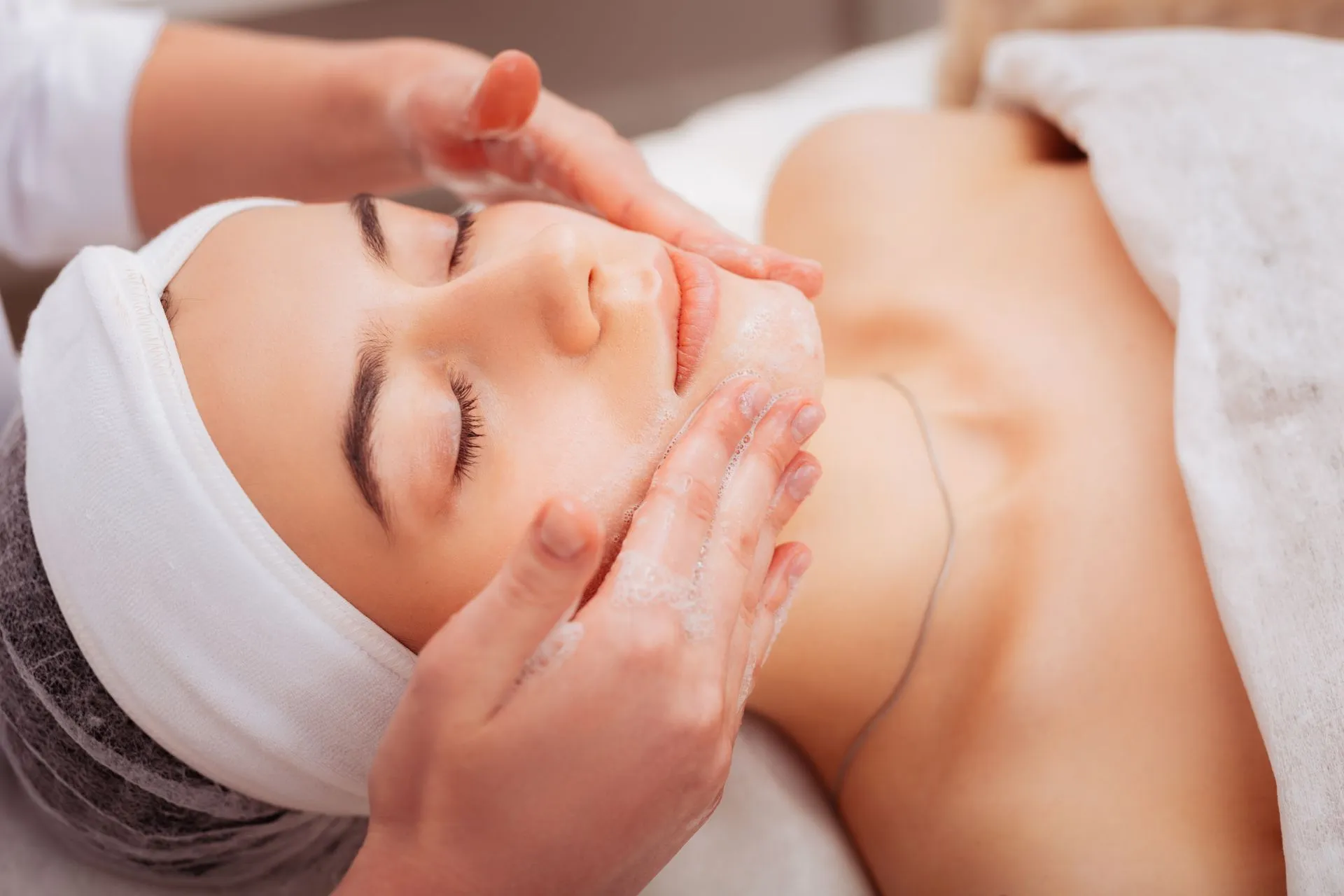 Kundin entspannt während professioneller Gesichtsbehandlung